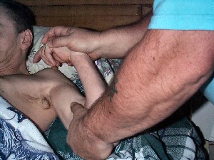 Michael Regina-Whiteley performing a routine massage technique designed to interrupt spastic muscles on his client, Butch.